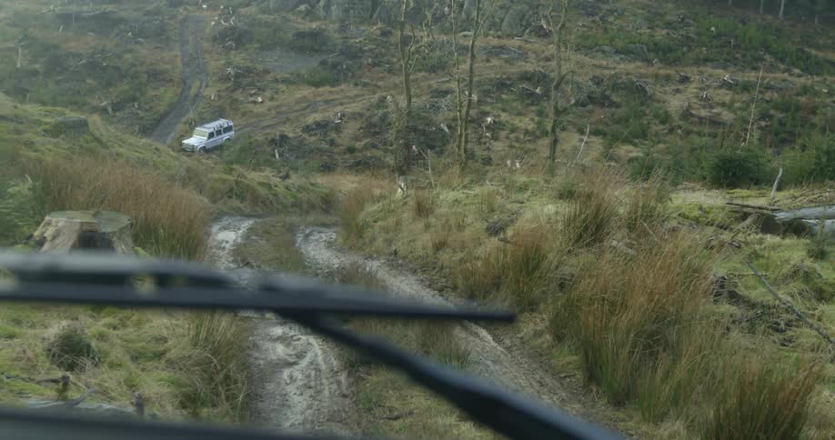 A car is driving through a rural area
