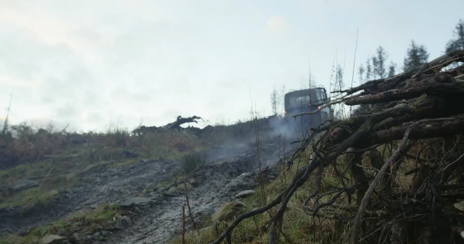 A truck driving up a hill outdoors
