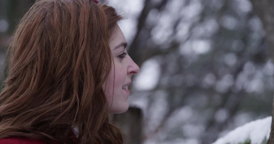 A woman smiles and looks up