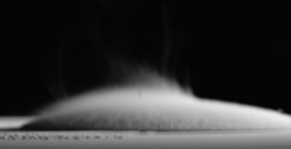 Abstract footage of liquid bubbling and steam rising from it