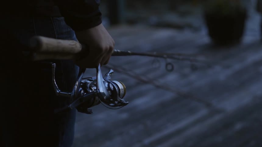 A person is holding fishing poles in their hands