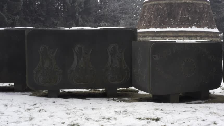 Geometrical carved sculptures standing in the snow in a park