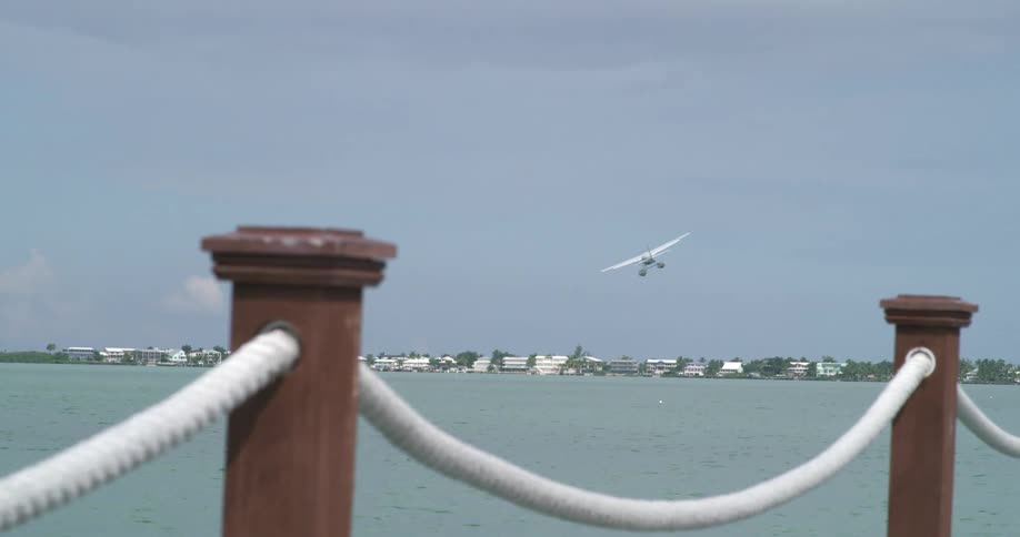 Seaplane taking off over a coastal town
