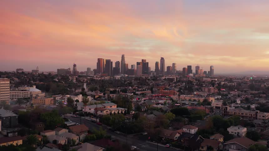 Aerial view of a neighborhood close to the citys downtown skyline at sunset