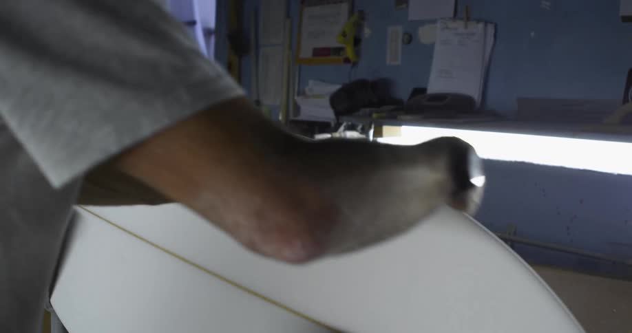 A person is waxing a surboard