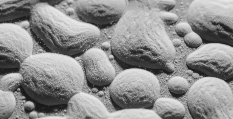 Gray vibrating powder in leveled clusters on a surface