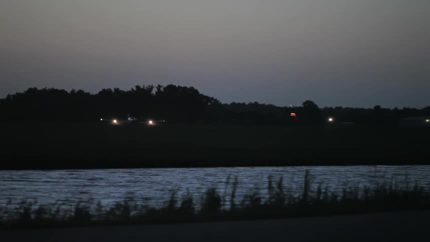 A plane lands in the dark
