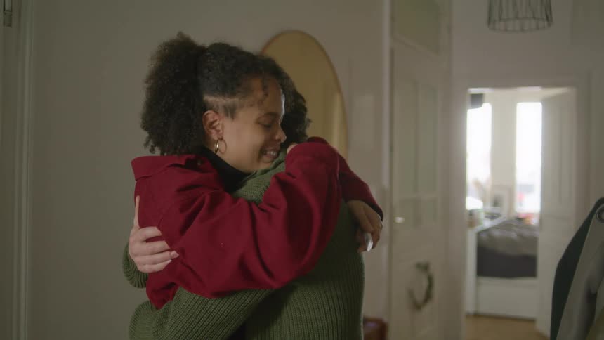 Couple hugs celebrating positive pregnancy test