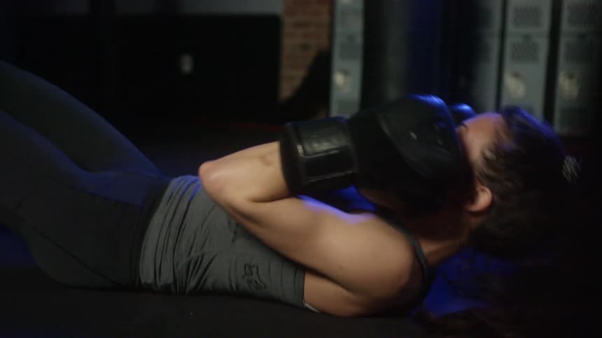 Woman combines sit ups with boxing exercise