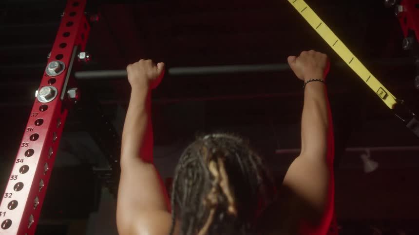 A man doing pull ups at a gym