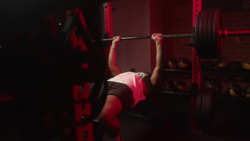 A man bench presses heavy weights