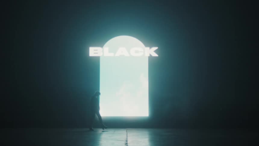 A woman walks past the large display in the dark