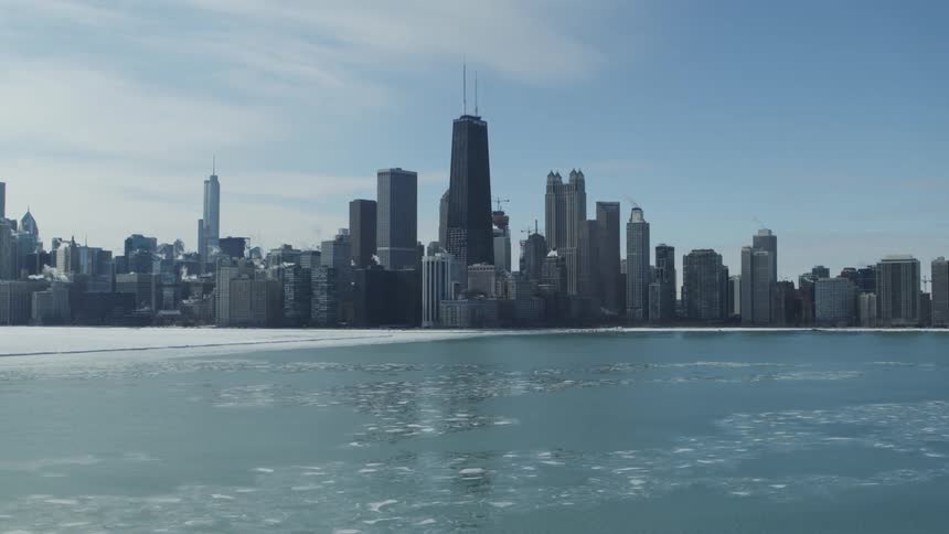 The John Hancock building surrounded by a frozen lake