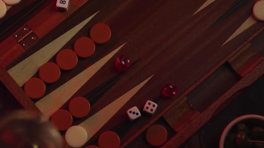 Dices are being thrown into backgammon board