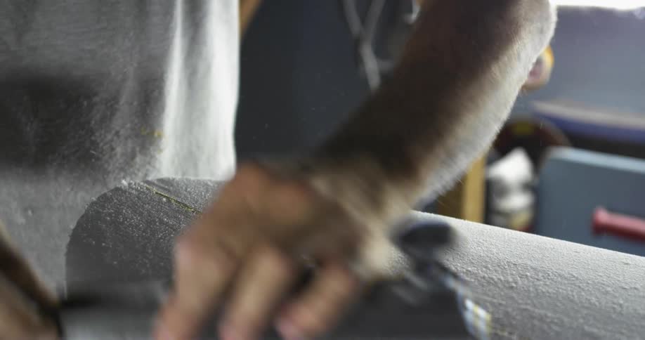 An employee working on a surfboard