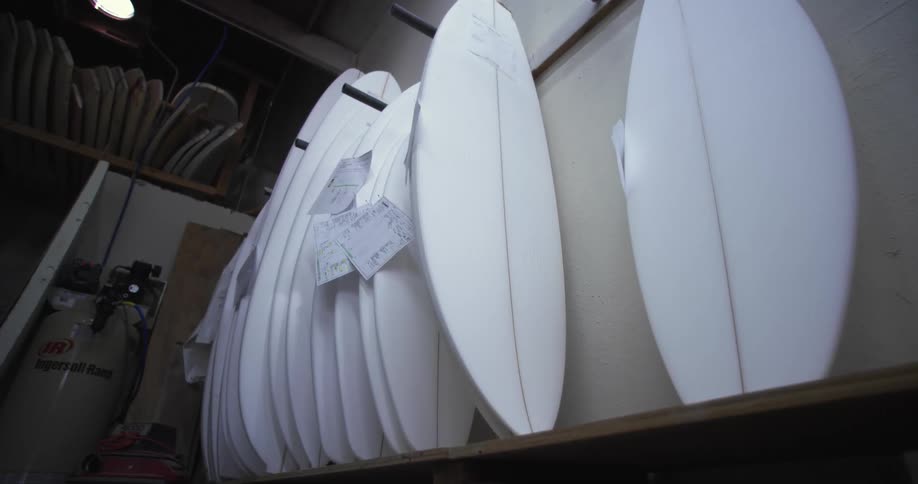White surfboards stand near wall