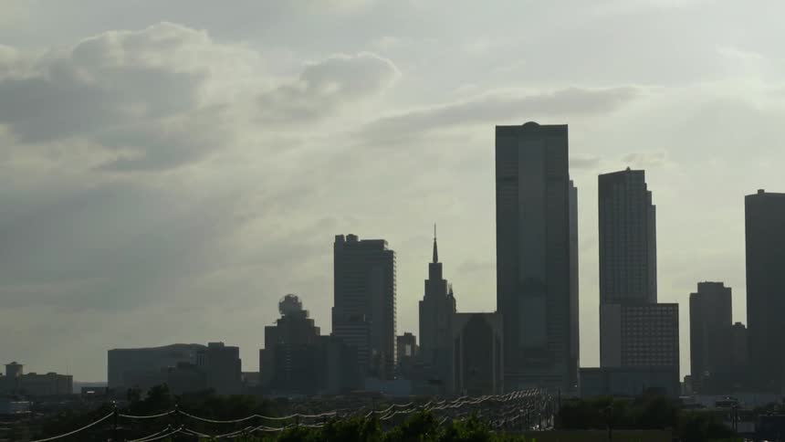 A city has very large buildings on a cloudy day