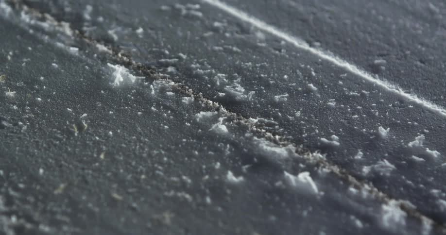 A hand rubbing over a gray surface