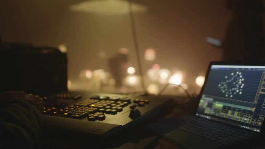 Filmmakers setting up a surreal scene with lamps inside a smoky room