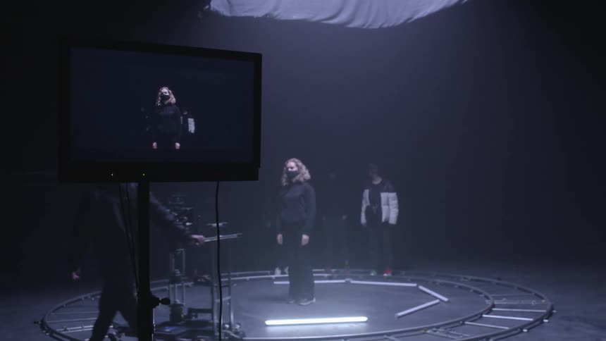 An actress being filmed on set indoors
