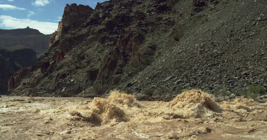 Heavy sediment and muddy Colorado River water heaves and explodes as it churns and tumbles through Grand Canyon National Park in Arizona before flowing downstream to Nevada and California