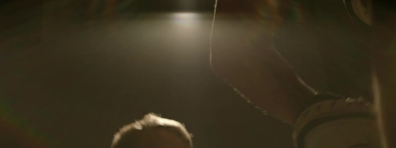 A child is boxing in the dark gym