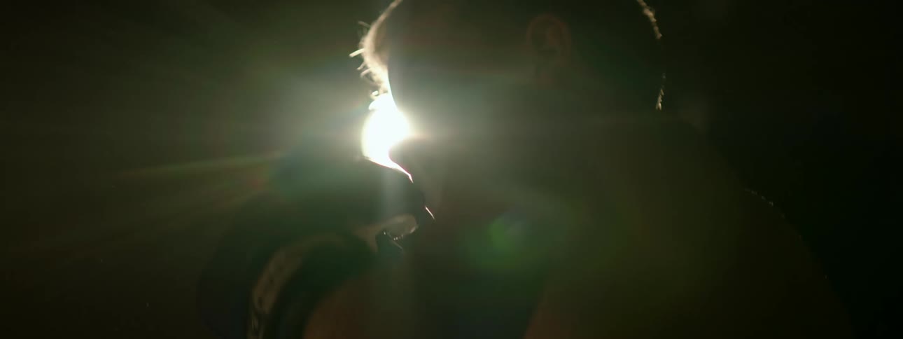 A child is boxing outdoors at night