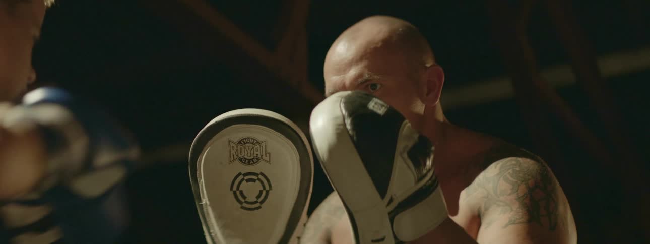 Man teaches boy how to box