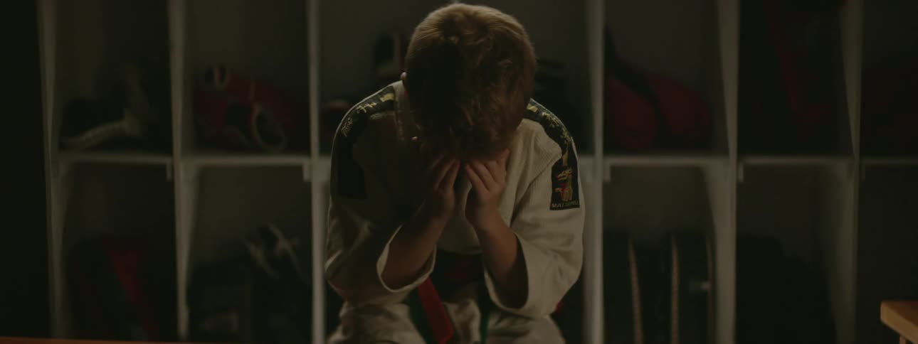 A child sitting crying into his hands