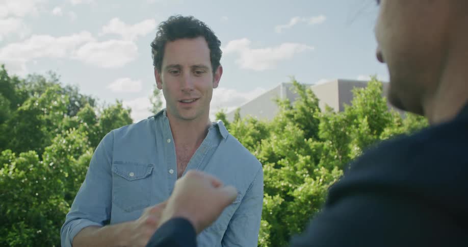 Two men talking and fist bumping