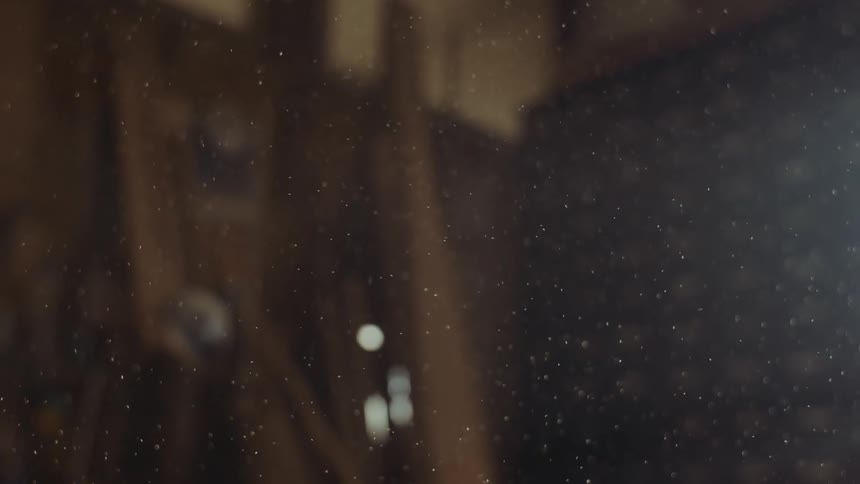 Heavy dust floats in the air in a room filled with wood pieces