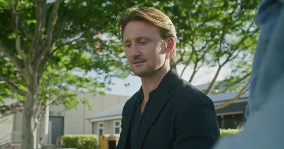 A man that is talking with someone else outside