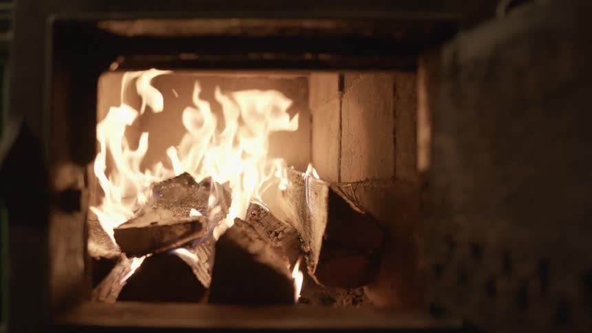 Burning flaming wood inside a furnace