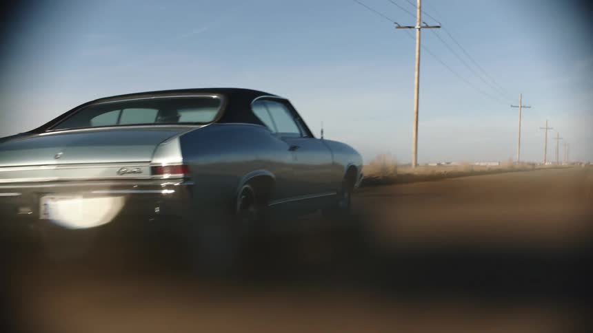 A man drives his car all over a road