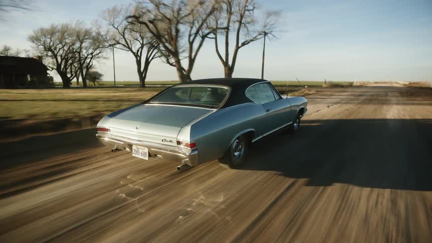 The car races down the dirt road