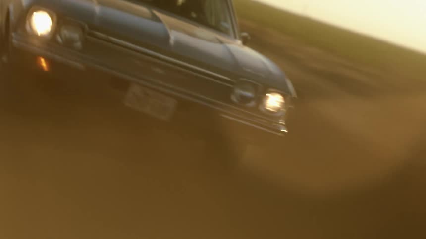 A vehicle is racing on the dirt road