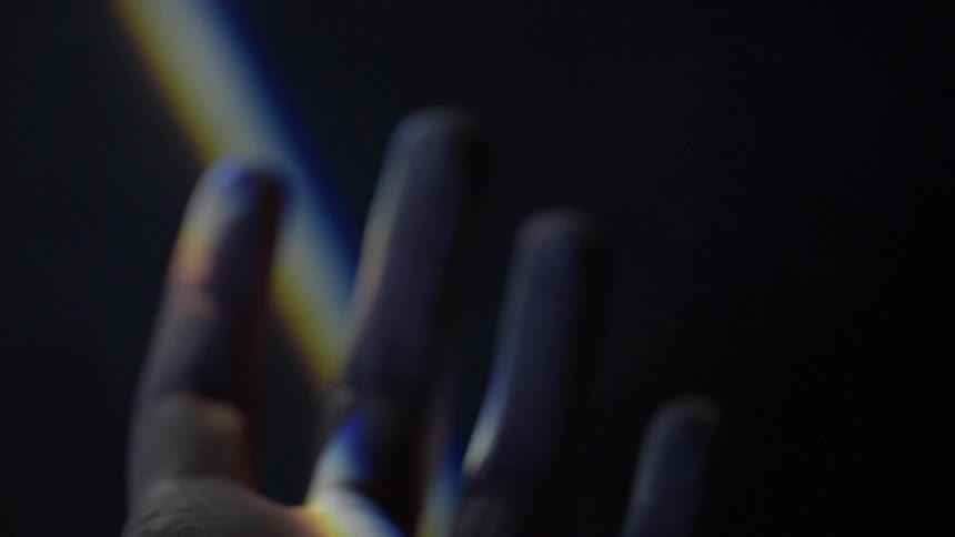 A close up view of a hand under a strip of light
