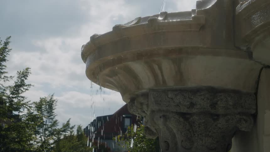A fountain in the yard is dripping water