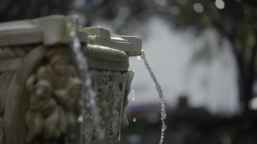 Water gently flowing from a decorative fountain