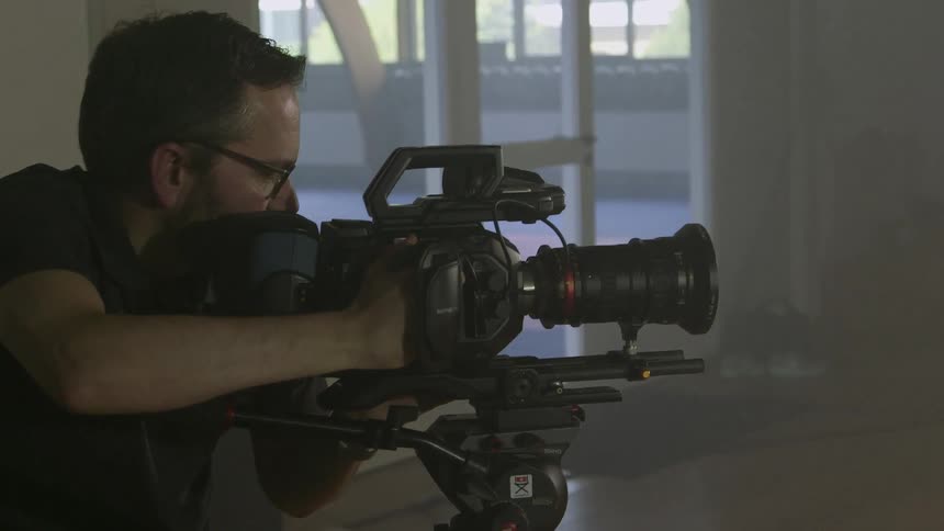 A camera man adjusts his camera