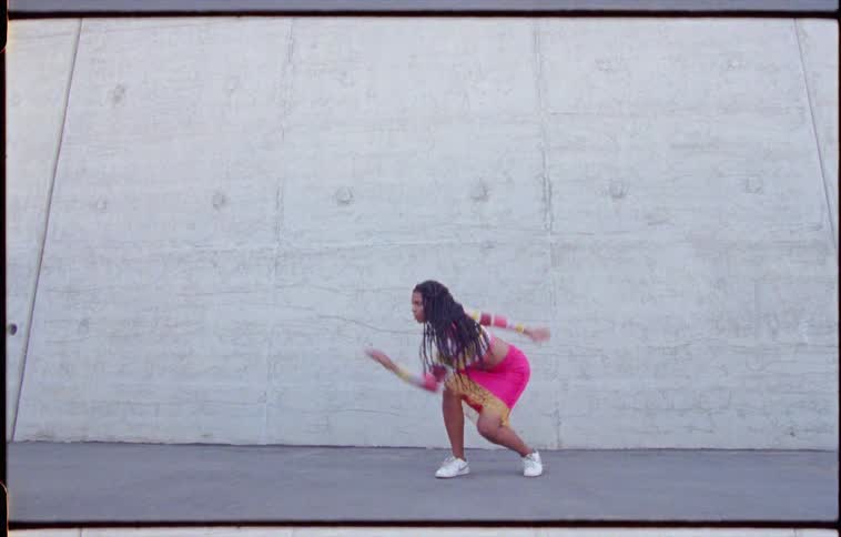 A woman dancing around outdoors