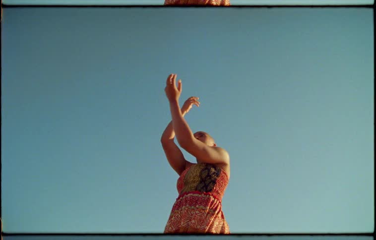 A woman is dancing outdoors in spring