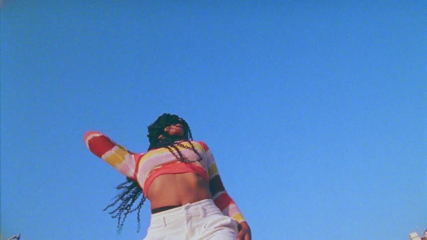 A young woman dances outdoors