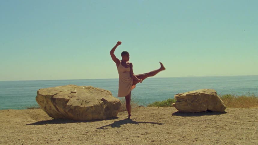 A woman that is dancing outdoors