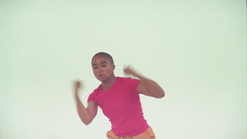 Bald woman energetically shaking his body while dancing