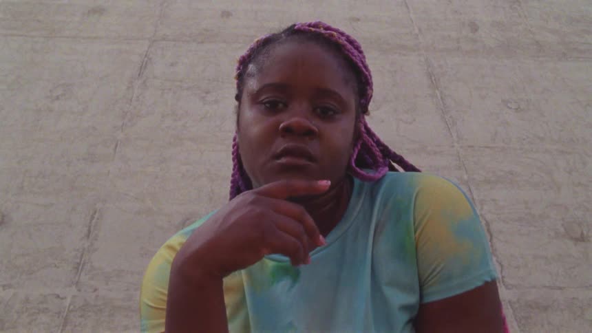A woman walking stooping down and staring