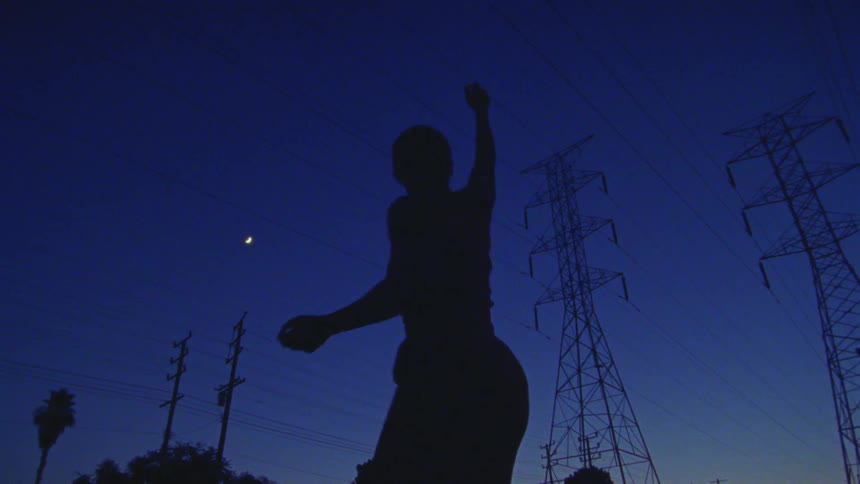 A person is dancing underneath the powerlines