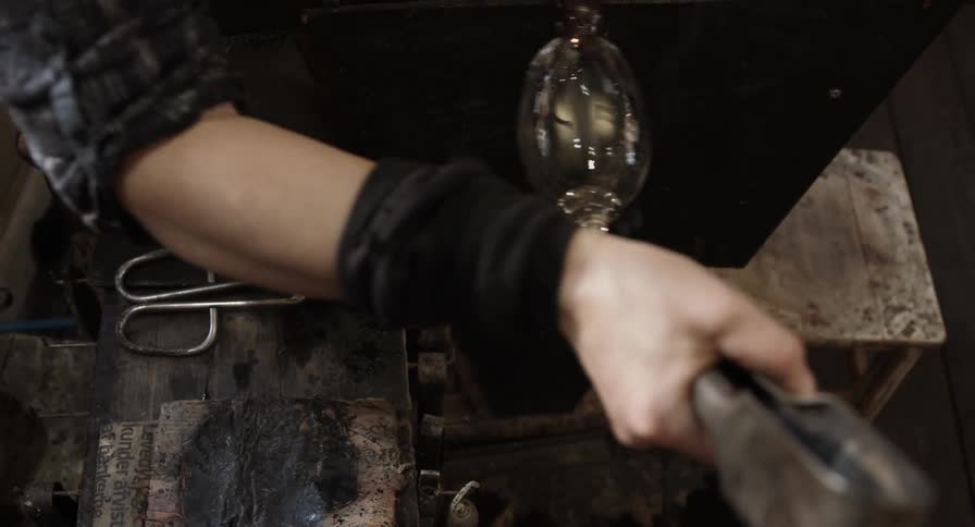 Woman creating a piece of glass