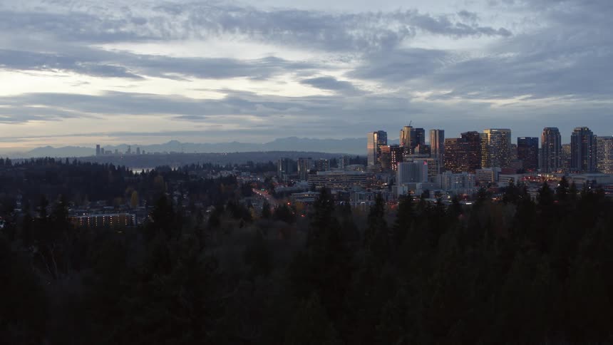 Slow pullback from the Bellevue skyline under a stunning sunset sky