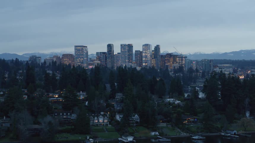 High end homes along the lakeshore in front of the Bellevue Washington skyline